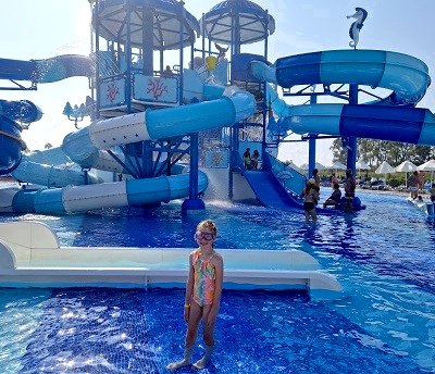 Girl in front of the waterslide at the Palm Wings waterpark