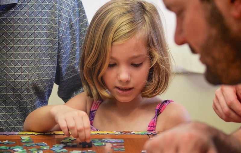 Playing a board game | Photo by: Debby Hudson, Unsplush