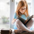 A girl in a ballet shoes reading a book | Photo by Andrea Piacquadio, pexels