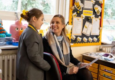 Greenbank Prep pupil and a teacher talking in the classroom