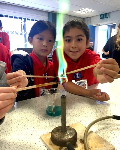 Girls with Bunsen burner | SciTech summer holiday camps