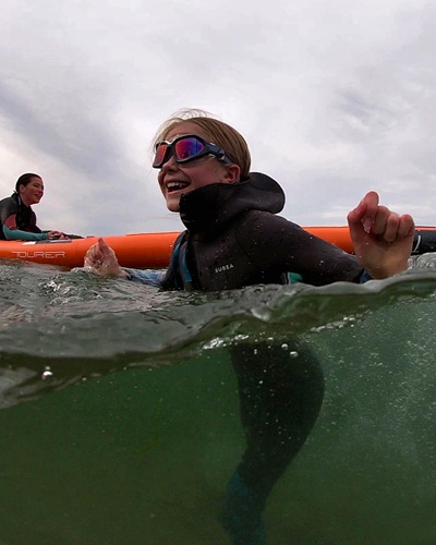 Girl in the water wearing Subea SCD wetsuit