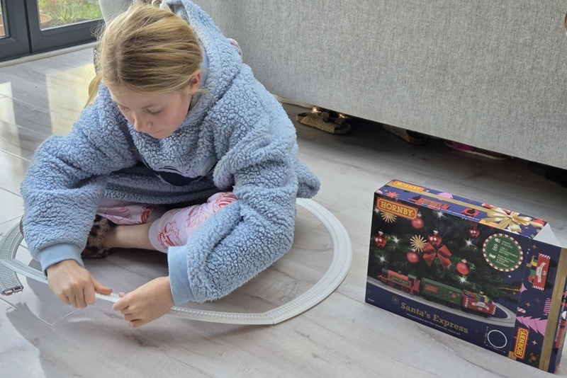 Girl assembles Hornby Train