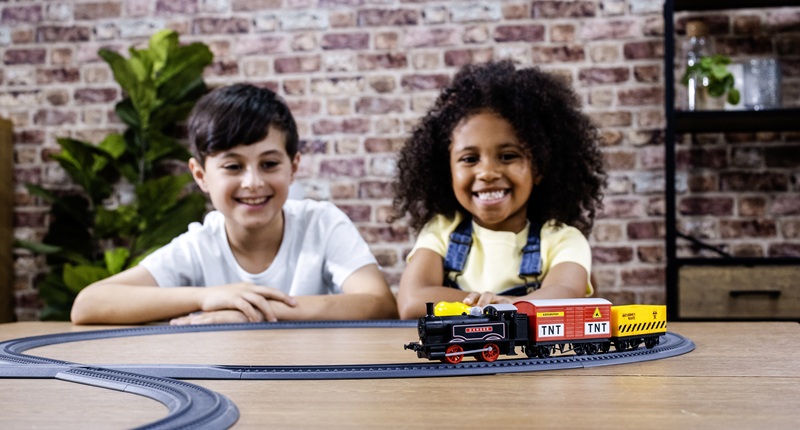 Kids playing with R9361M Playtrains Steam Goods Express Train Set