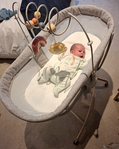 Baby in a Chicco Baby Hug crib in the bedroom