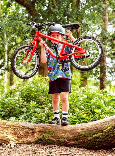 Adam LV Photography | Boy lifting red YOMO Bike