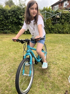 Girl on a bike in her garden