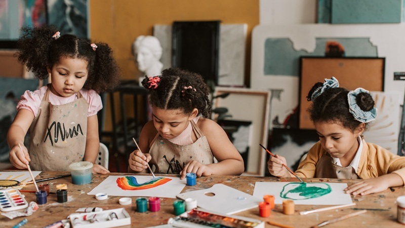 Three girls are drawing