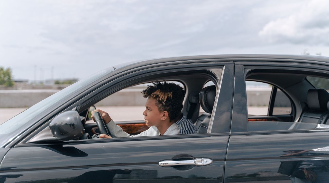 A boy driving a car