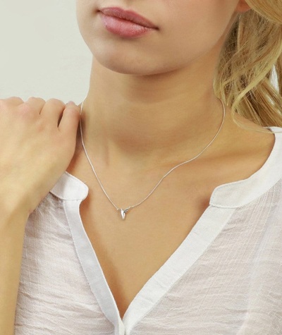 Young woman wearing small hummingbird necklace by Jana Reinhardt