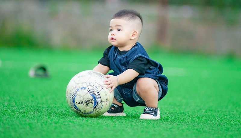 Little boy playing football
