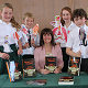 Mrs Kate Sargent and CHS students Anna Cusworth, Oliver Brown, Isabelle Ashworth and Thomas Scott, with props which illustrate the costumes worn at the time the book was set.