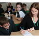 Caroline Broster demonstrates shorthand note-taking to Samuel Bowker and Orla Fox-Partridge