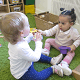 Toddler sharing a toy