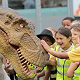 School children and a dinosaur | Jurassic Kingdom