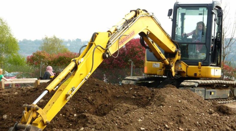 Girl on a digger at Diggerland in Kent