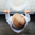 Baby looking outside through the glass door | photo: Paul Hanaoka, unsplash