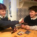 Boys playing Fame or Forfeit card game
