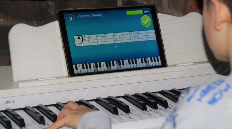 Boy learning to play piano