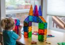 Girl playing with Magna-Tiles building blocks