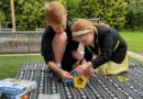A boy and a girl playing with GeoMag Supercolour Panels play set