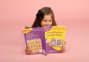 Girl with Collins's comprehension bumper book