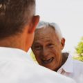 Old man speaking with younger man | photo by Logan Weaver