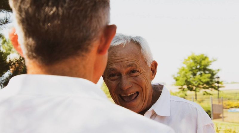 Old man speaking with younger man | photo by Logan Weaver