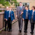 Jason Slack, Head of Foundation at The King's School in Macclesfield, with pupils on the school's bridge