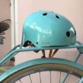 Bobbin's green Starling bike helmet on a bicycle seat.