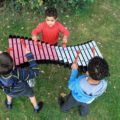 Kids with giant metal xylophone in the park