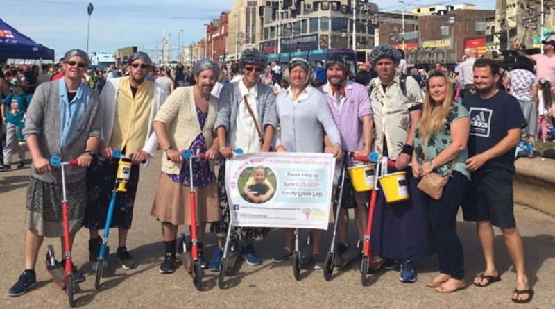 Grannies at the Blackpool Tower with a check for a charity