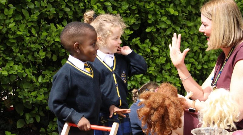 School kids listen to teacher