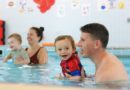 Families in the swimming pool at the Water Babies Splashathon event