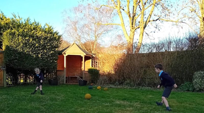 Children playing football in the garden