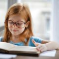 Girl reading a book for her homework | photo by Andrea Piacquadio, pexels