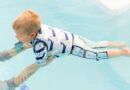 Boy in a water wearing Splash About Moby print swim vest