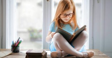 A girl in a ballet shoes reading a book | Photo by Andrea Piacquadio, pexels