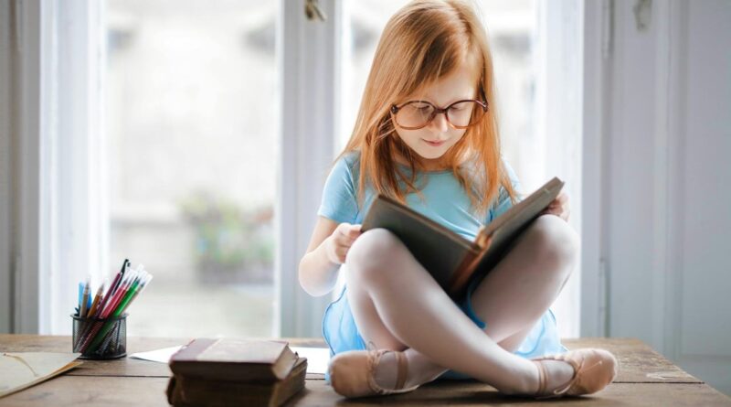 A girl in a ballet shoes reading a book | Photo by Andrea Piacquadio, pexels