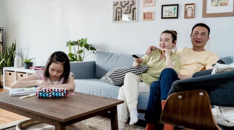 Parents are watching TV while girl is studying | Photo by Annushka Ahuja, pexels