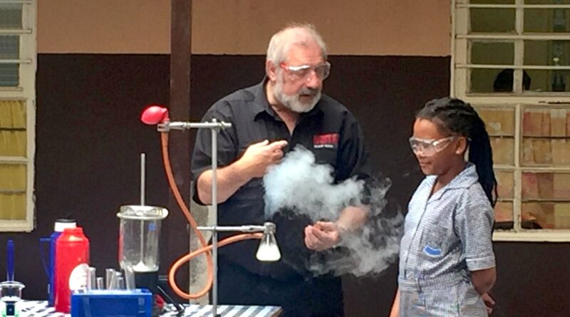 Philip Rose and a girl with a conical flask
