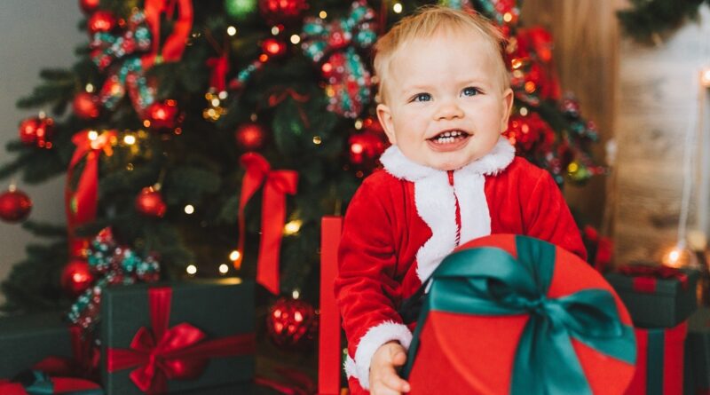 Cheeky toddler with a Christmas present