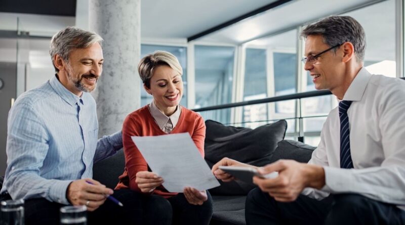 A couple discussing a document with their lawyer