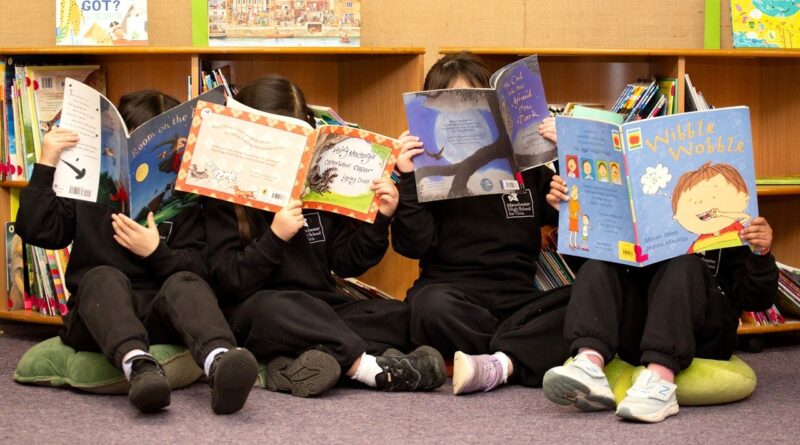 Manchester High early years pupils reading at the school's library