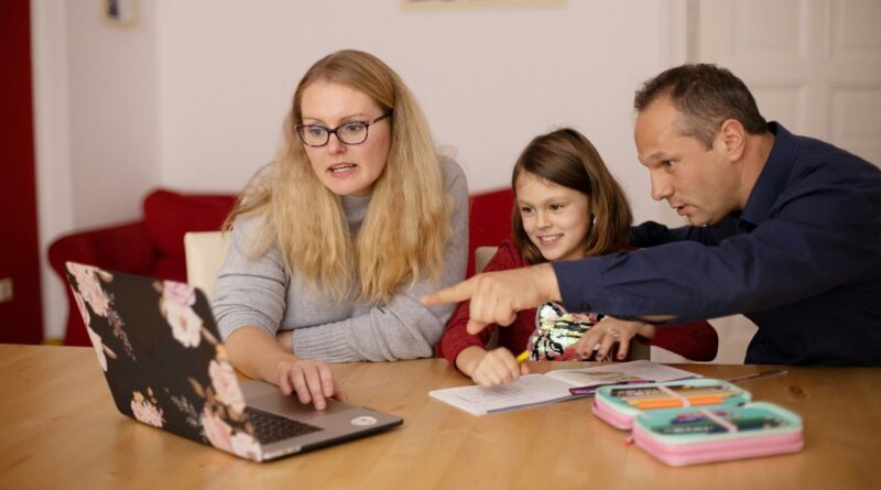 Two adults and a girl with the computor