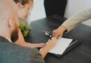 A man and a woman signing some papers