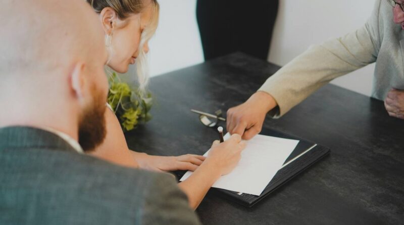 A man and a woman signing some papers