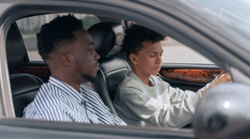 Father and son are driving a car
