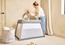 IBLI Scout 3 in 1 Travel Crib, Cot and Playpen | Mother putting a baby in the cot