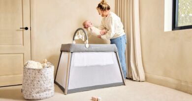 IBLI Scout 3 in 1 Travel Crib, Cot and Playpen | Mother putting a baby in the cot